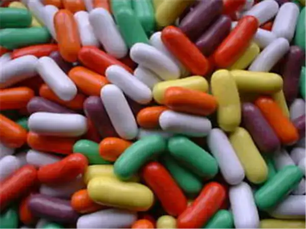 Vibrant assorted candy pills in various colors for treats and party favors.