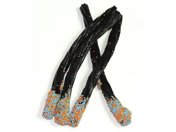Delicious black licorice twists decorated with vibrant multicolored sprinkles, perfect for candy lovers.