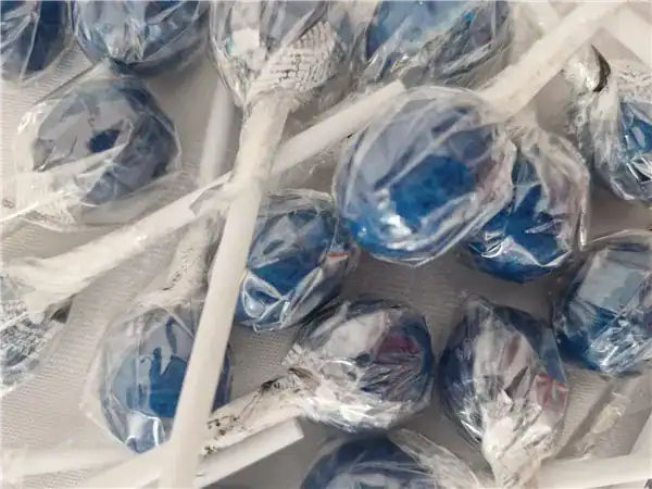 Colorful lollipops wrapped in shiny foil for kids and adults.