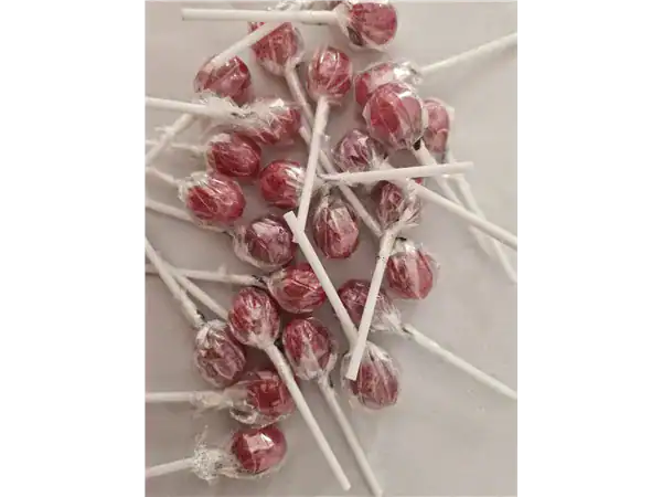 Colorful swirl lollipops with white sticks, perfect sweet treats from Roch Sweets.