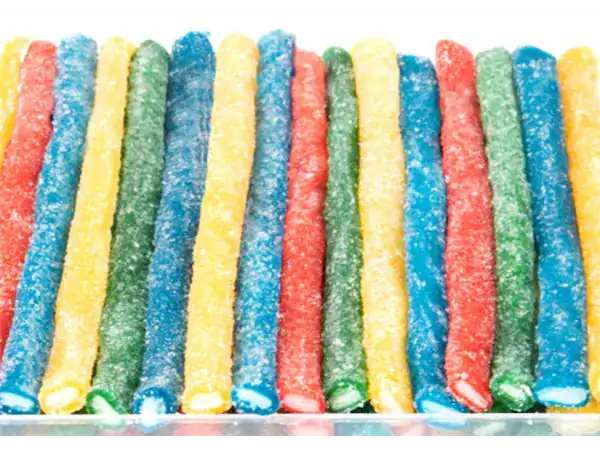 Vibrant rainbow sour candy sticks coated with sugar, perfect for sweet and tangy indulgence.