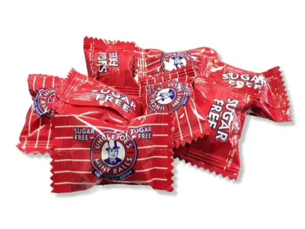 Colorful sugar-free candy wrapped in red packaging with Roch Sweets logo.