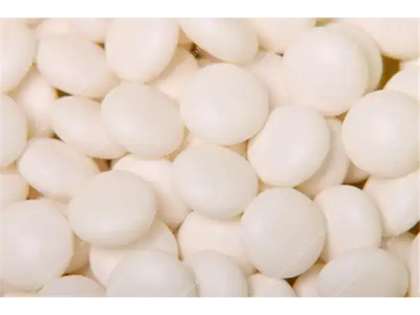 Close-up of white peppermint candies for sale.