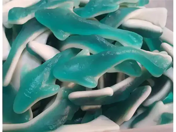 Bright blue and white sour gummy worms close-up shot.